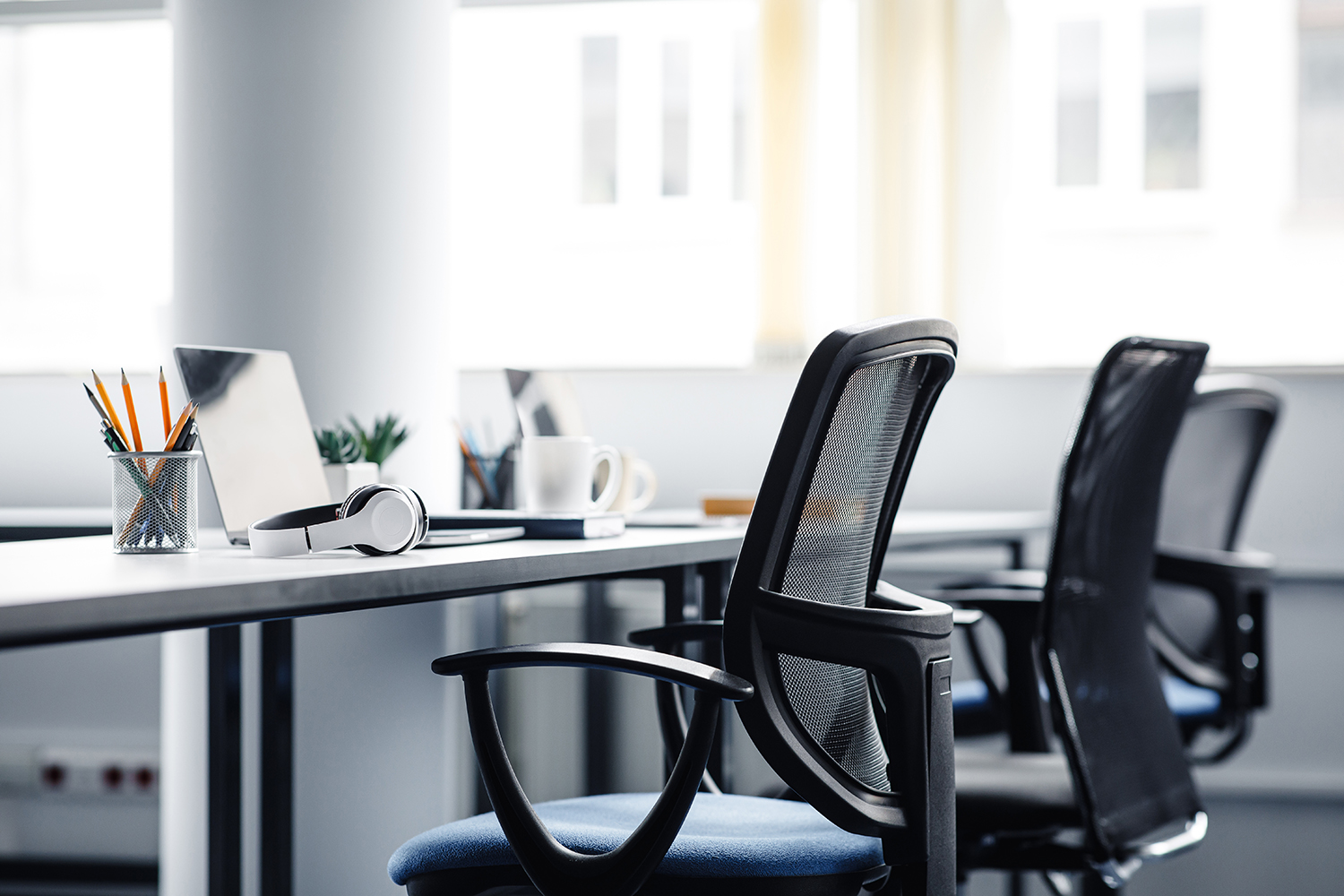 office furniture, including ergonomic computer chairs and a granite top desk